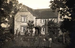Low Farm in the 1930s Article Photo - The farmhouse at Low Farm, with Ada Woodruff at the front door